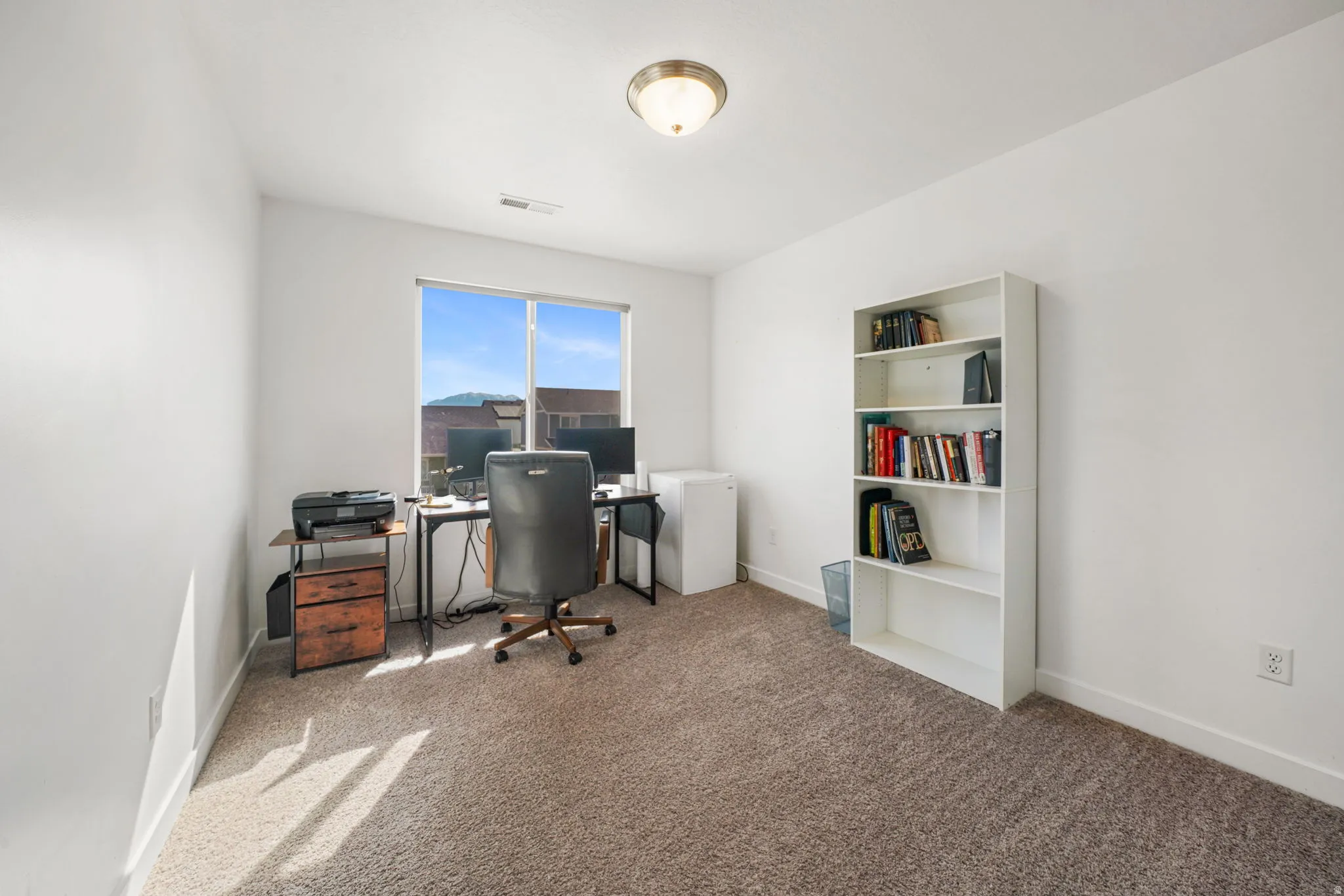 Home office with carpet floors and baseboards