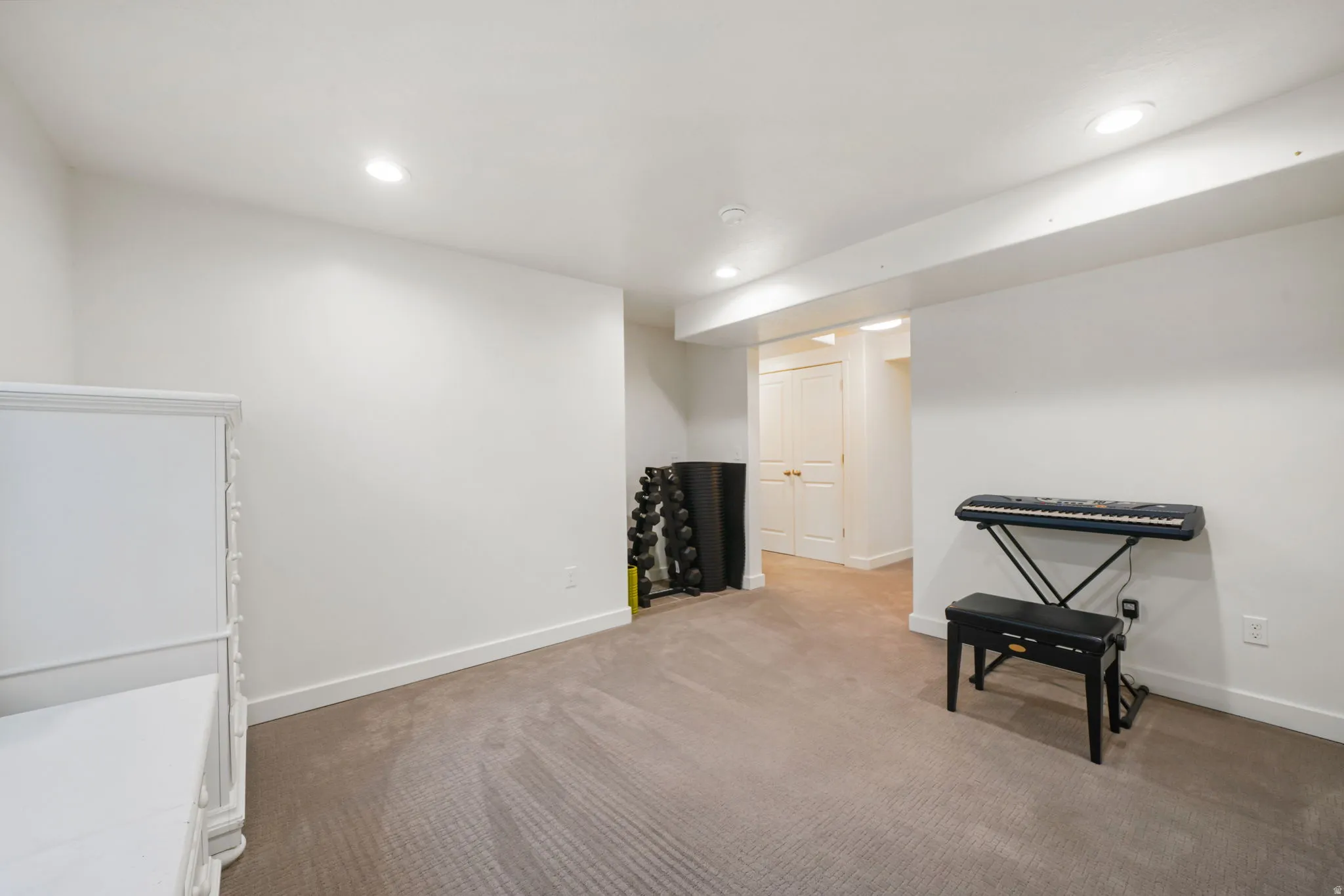 Recreation room with recessed lighting and light colored carpet