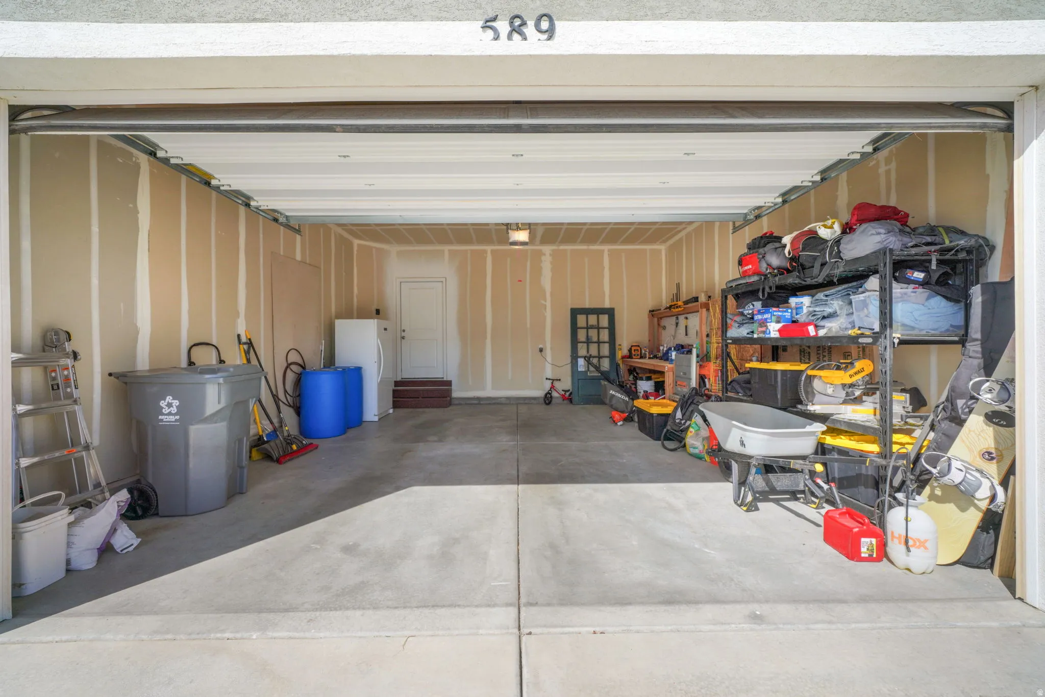 Garage with freestanding refrigerator