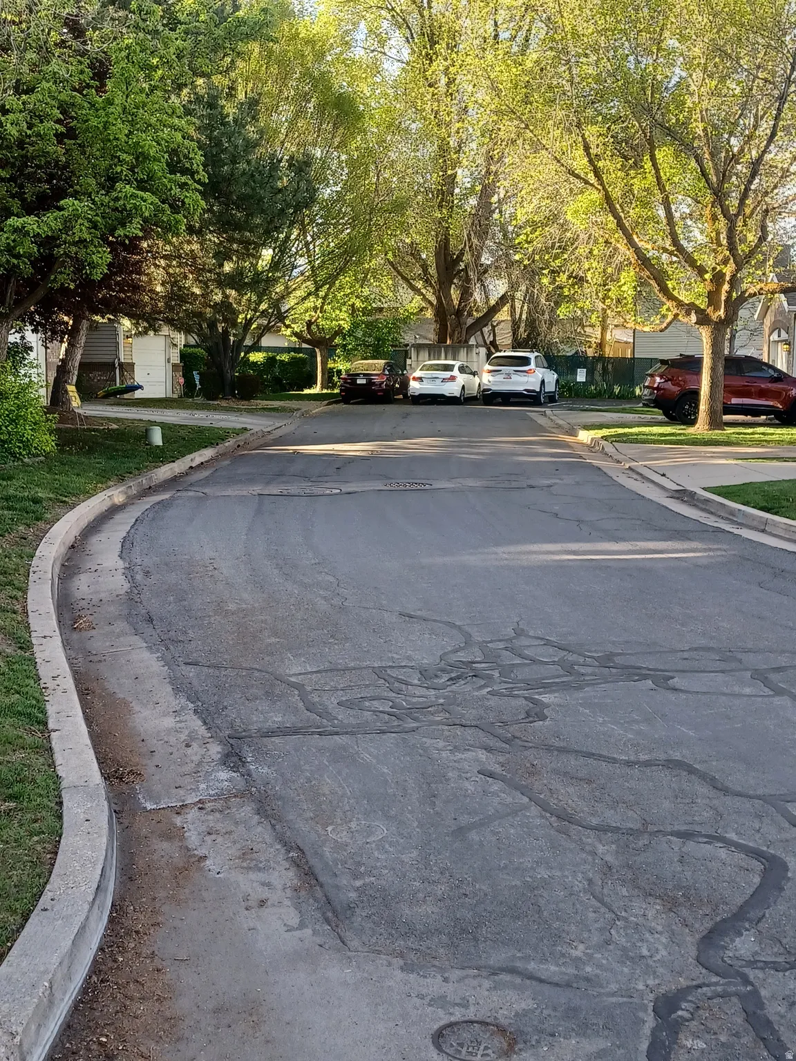 View of asphalt street with curbs