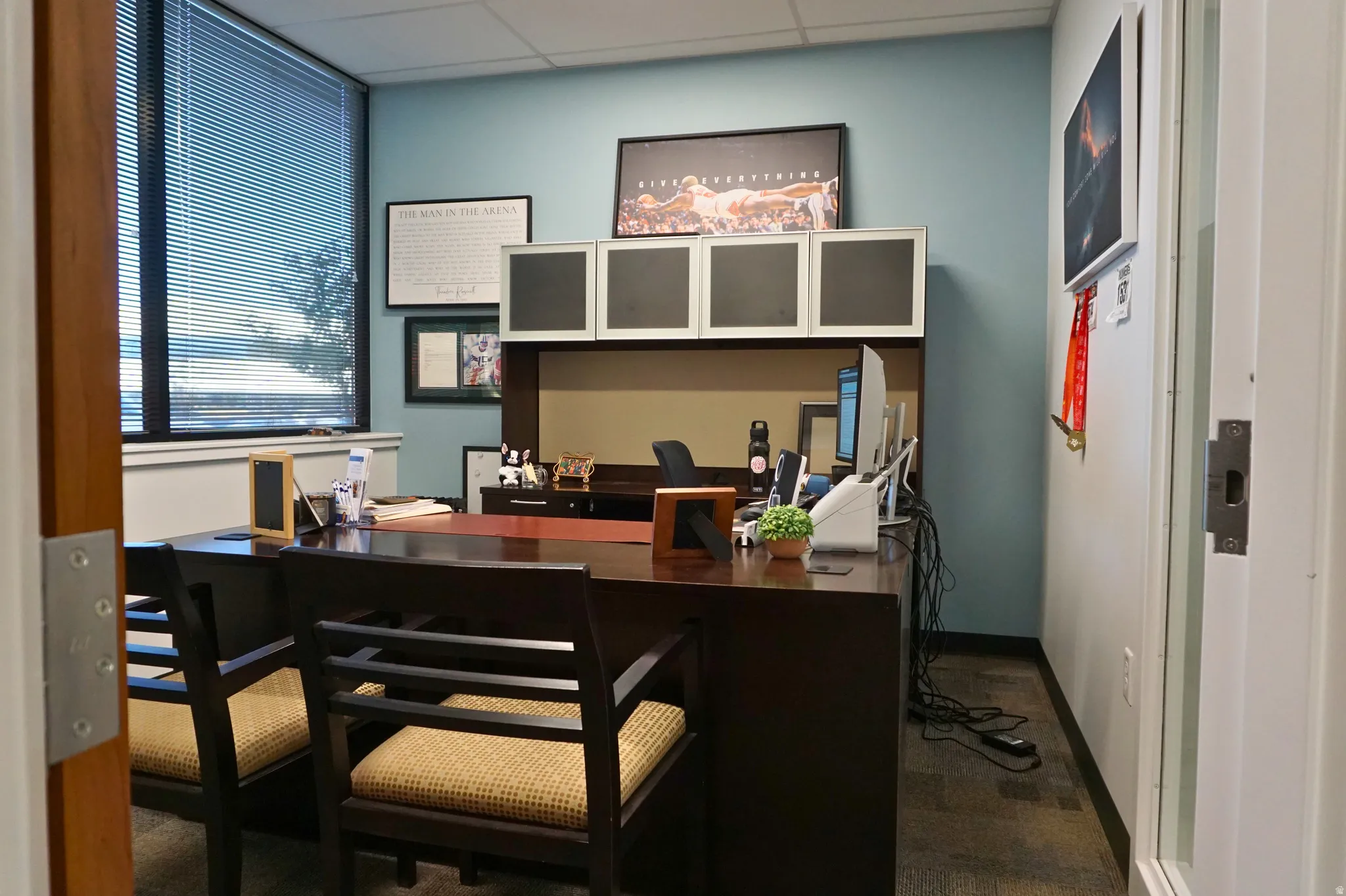 Office space with a paneled ceiling