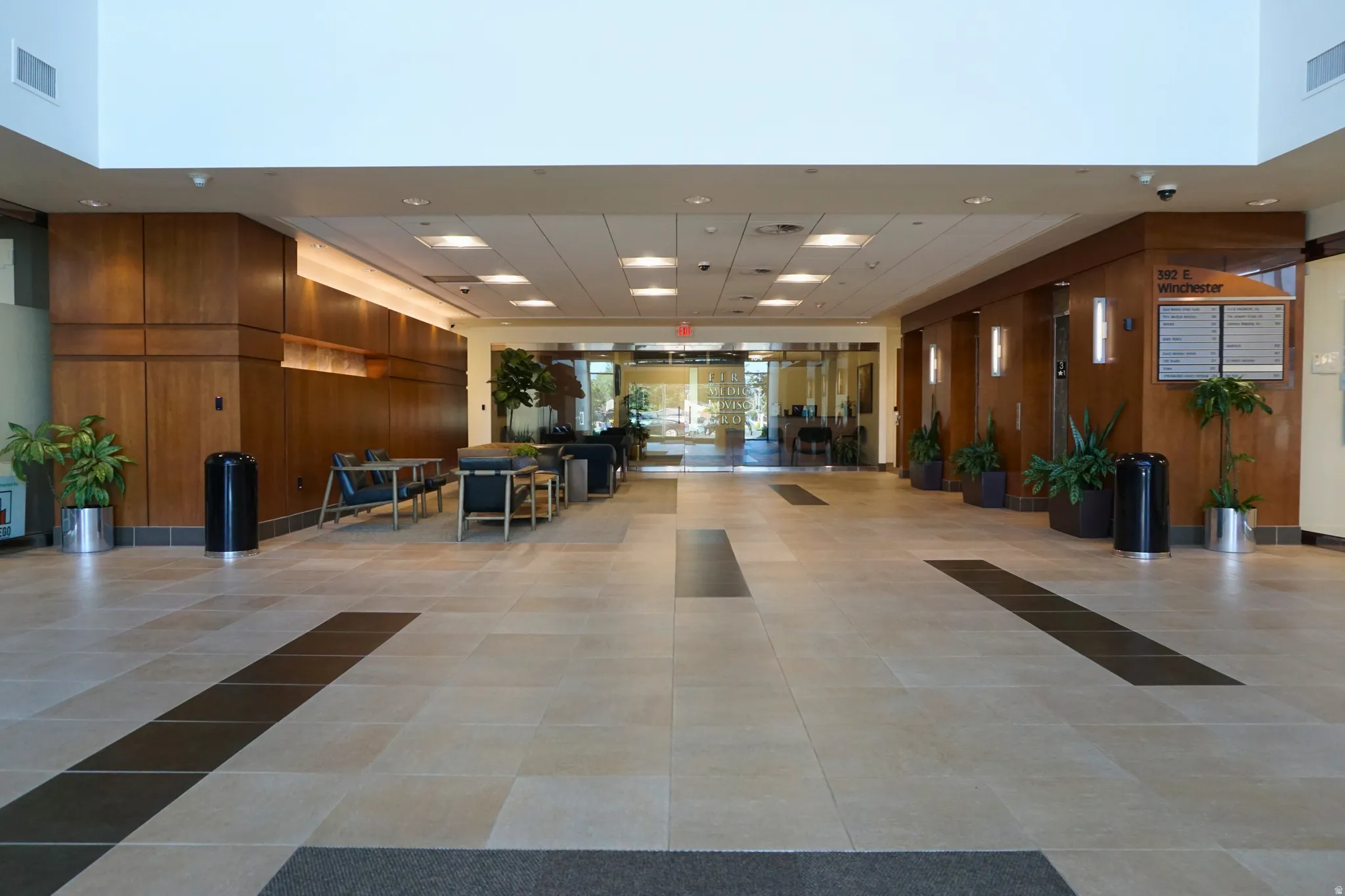 Common area featuring wood walls, recessed lighting, and a high ceiling