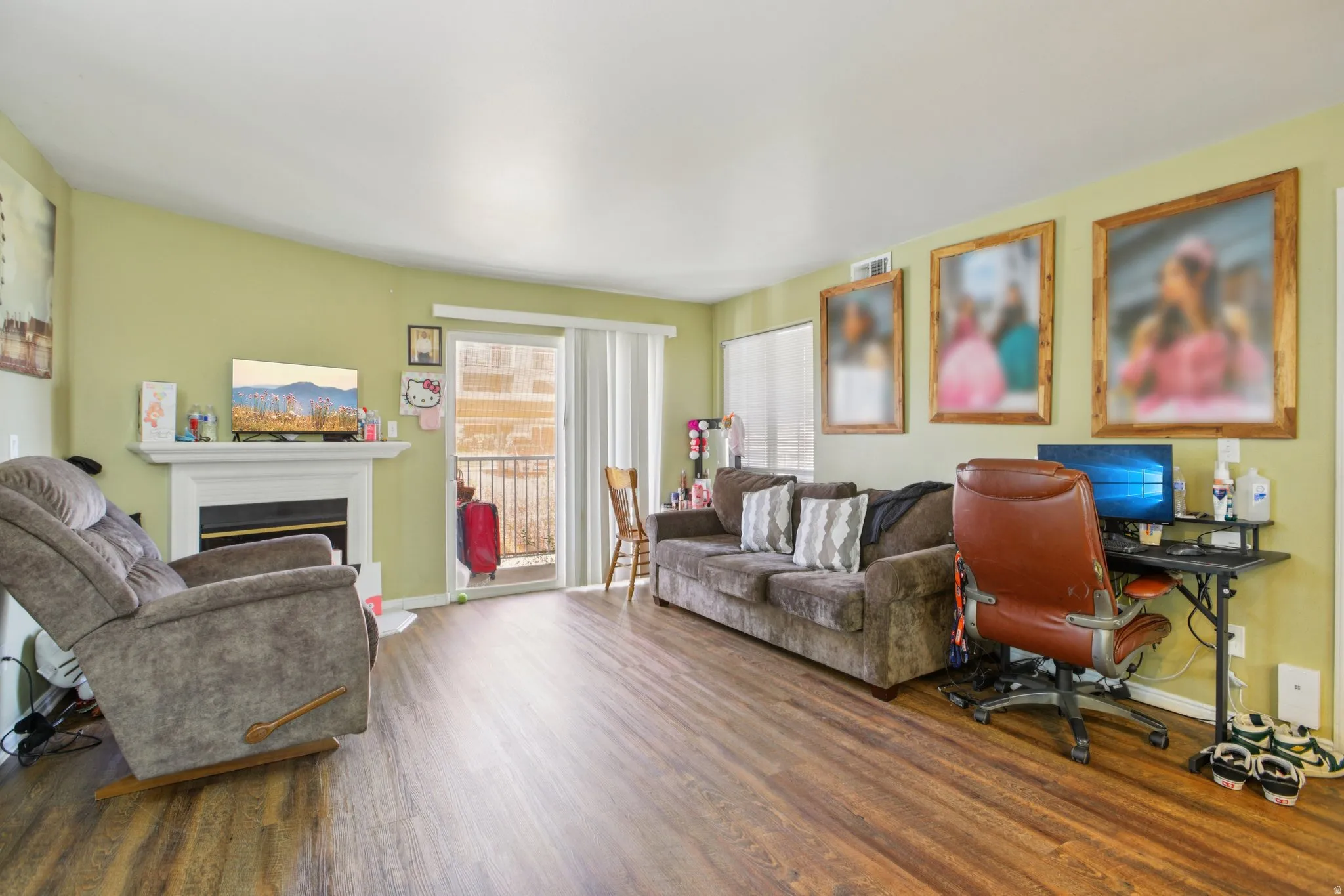 Home office featuring a fireplace and finished floors