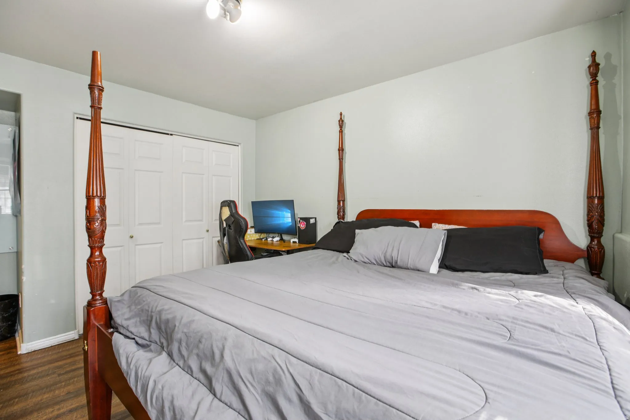 Bedroom featuring a closet and dark wood-type flooring