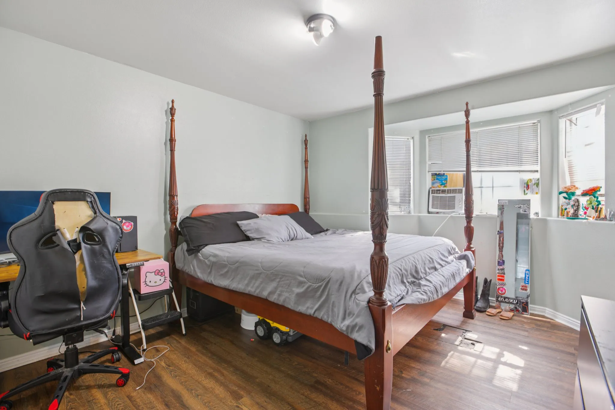 Bedroom featuring dark wood-style floors, a desk, and cooling unit