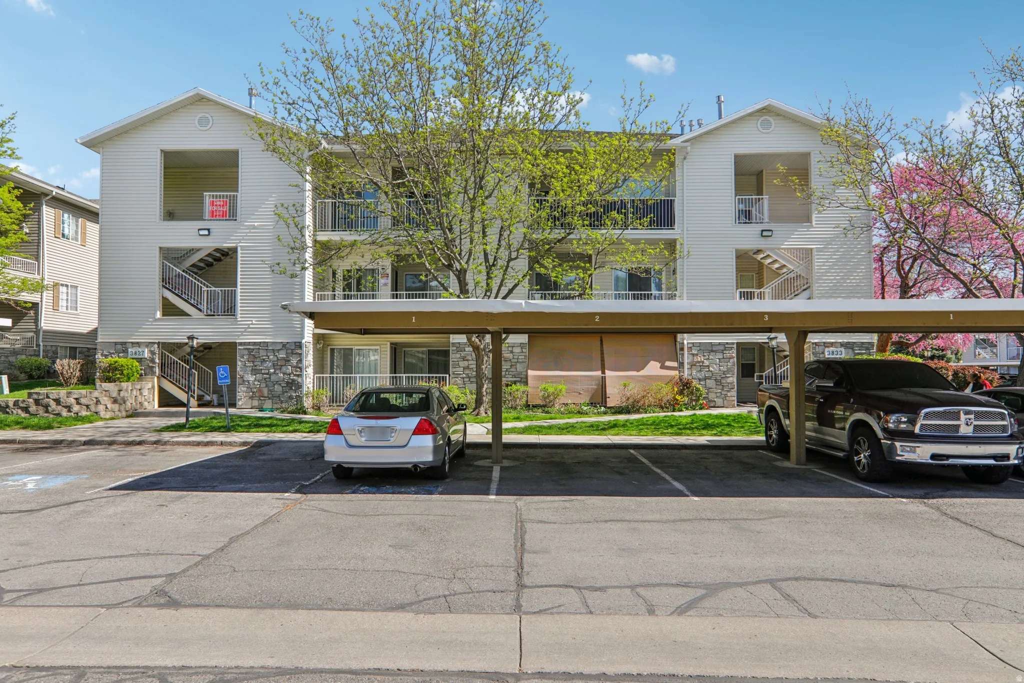 View of apartment building / complex with covered parking