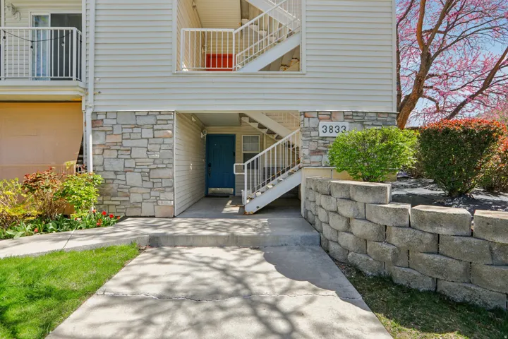 View of exterior entry featuring stone siding