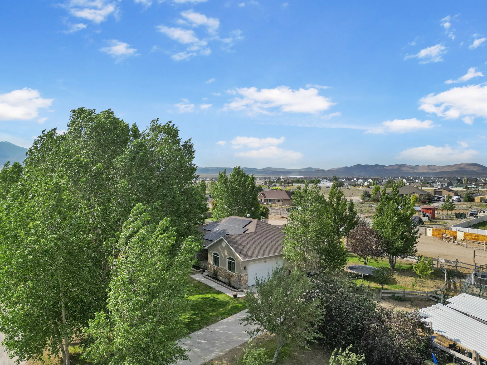 Aerial perspective of suburban area with a mountainous background