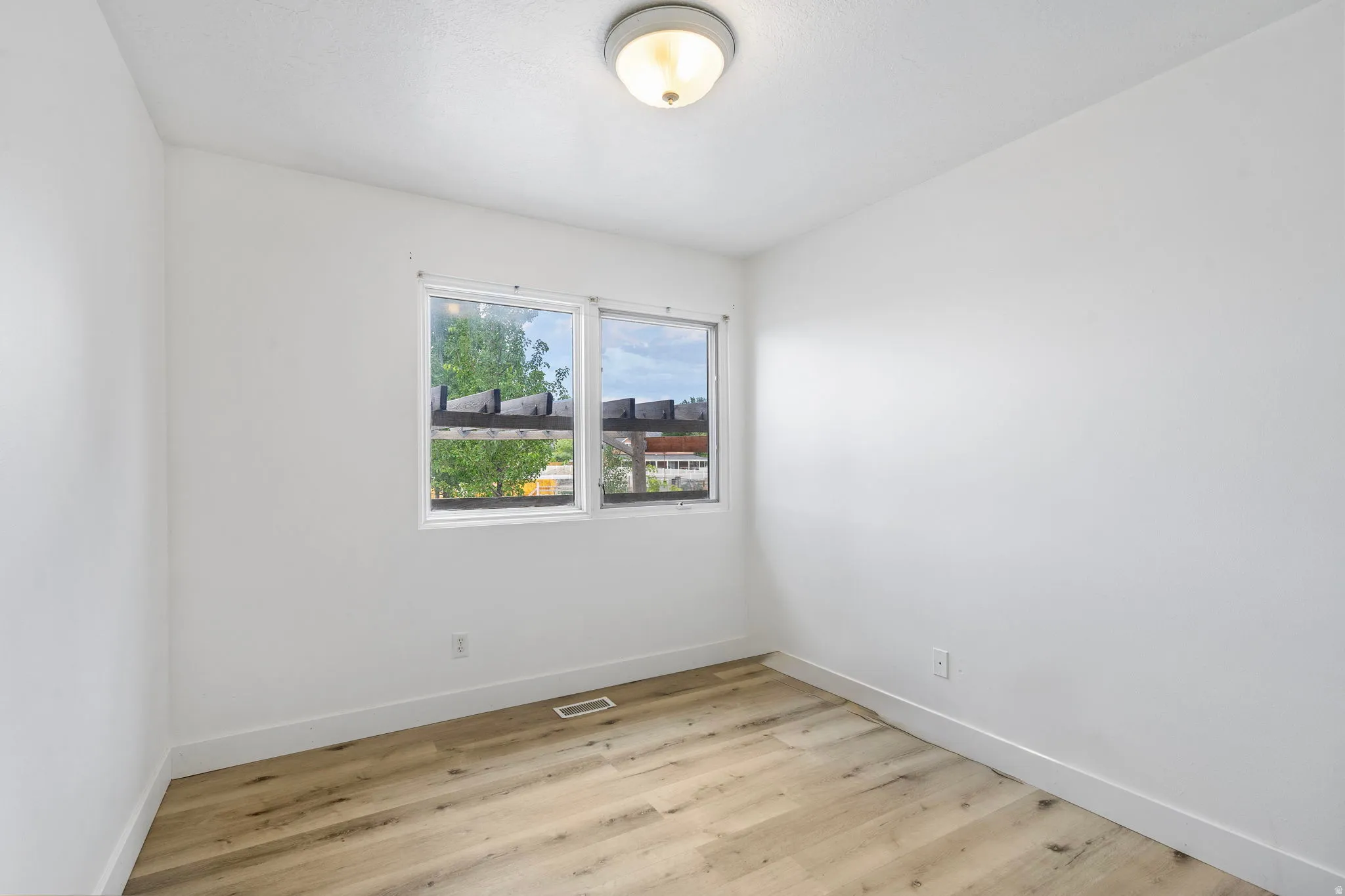 Empty room featuring light wood-style floors and baseboards