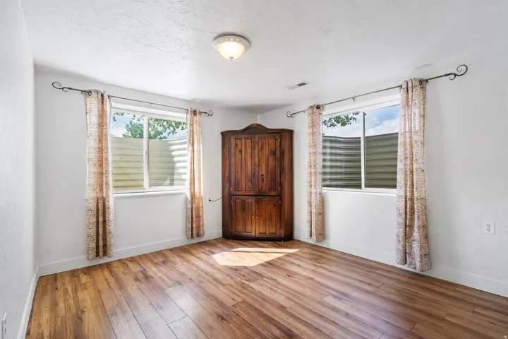Empty room featuring light wood-style floors and a textured ceiling