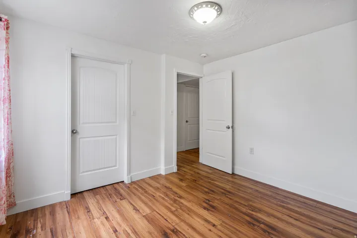 Unfurnished bedroom with light wood-style flooring and a textured ceiling