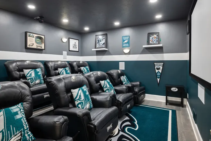 Cinema room with recessed lighting and wood finished floors