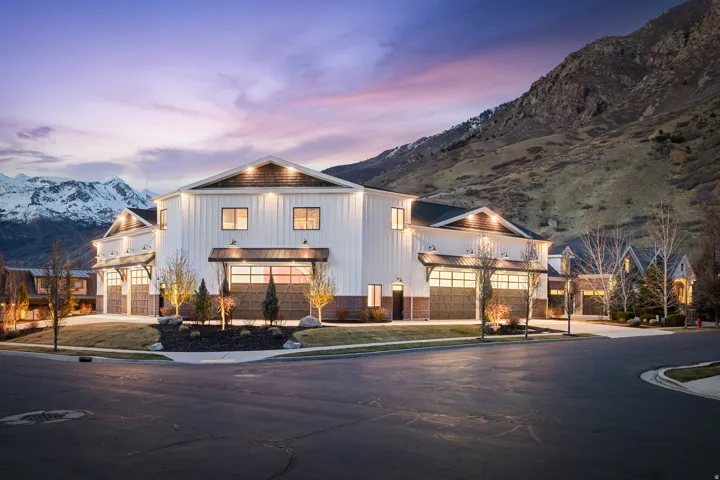 Modern inspired farmhouse with a mountain view, concrete driveway, and board and batten siding