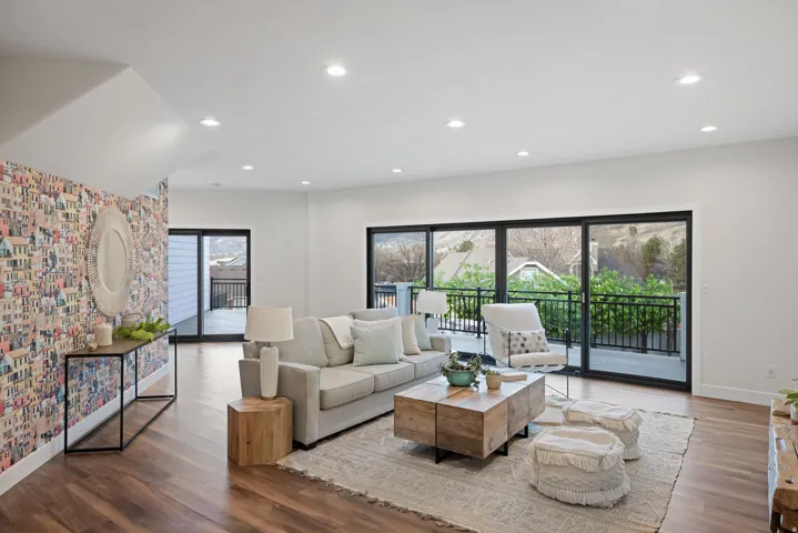 Living area with wood finished floors and recessed lighting