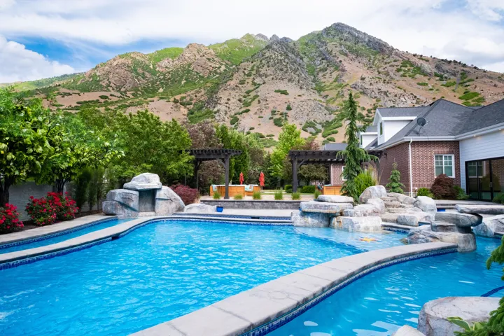 Swimming pool featuring a patio area, a pergola, a jacuzzi, and a mountain view