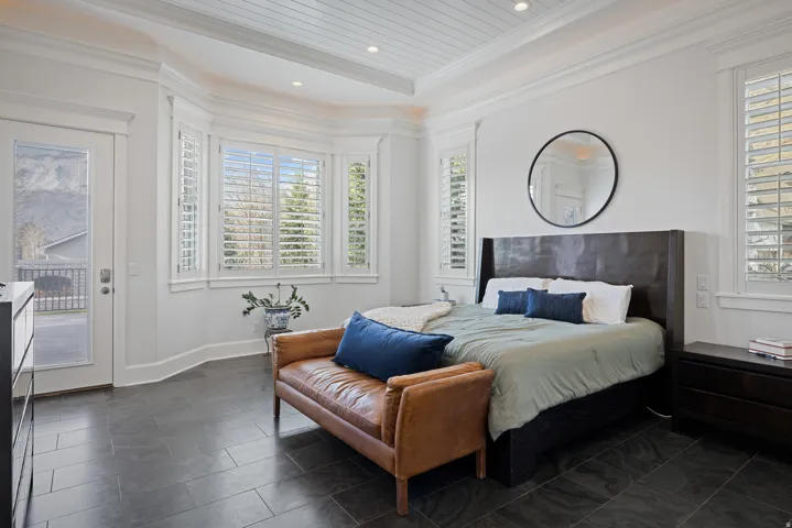 Bedroom featuring access to exterior, multiple windows, recessed lighting, and ornamental molding