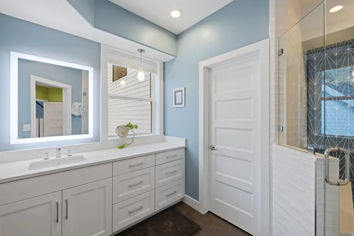 Full bathroom featuring a stall shower, vanity, dark tile patterned floors, and recessed lighting