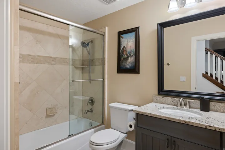 Full bathroom featuring vanity and combined bath / shower with glass door
