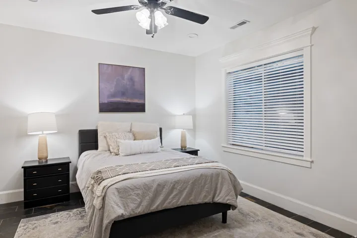 Bedroom featuring baseboards and ceiling fan