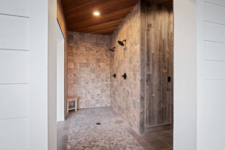 Full bathroom with wooden ceiling and tiled shower