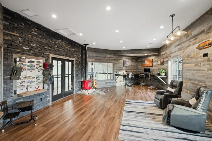Living area featuring french doors, plenty of natural light, recessed lighting, and wood finished floors