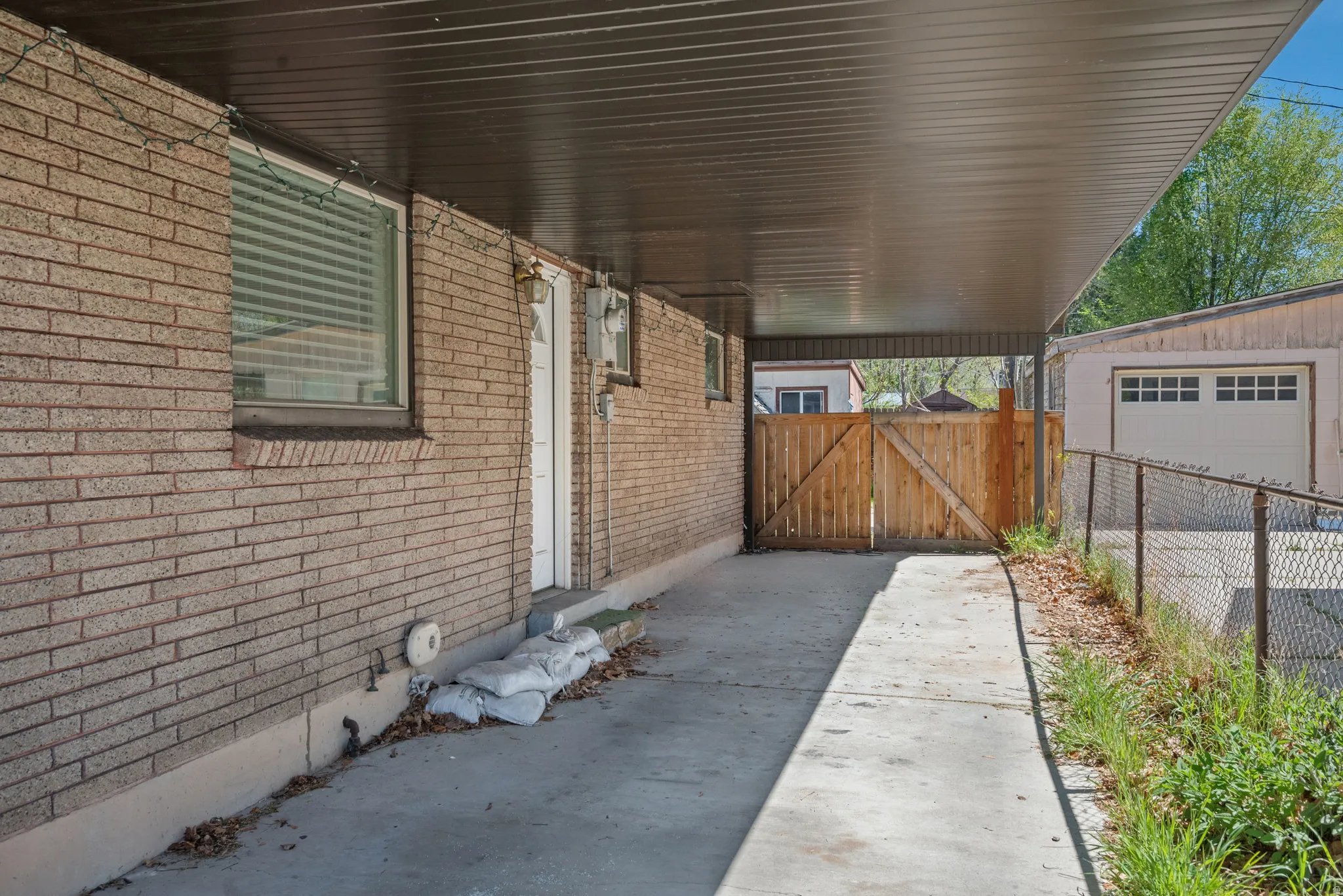 View of patio featuring a gate