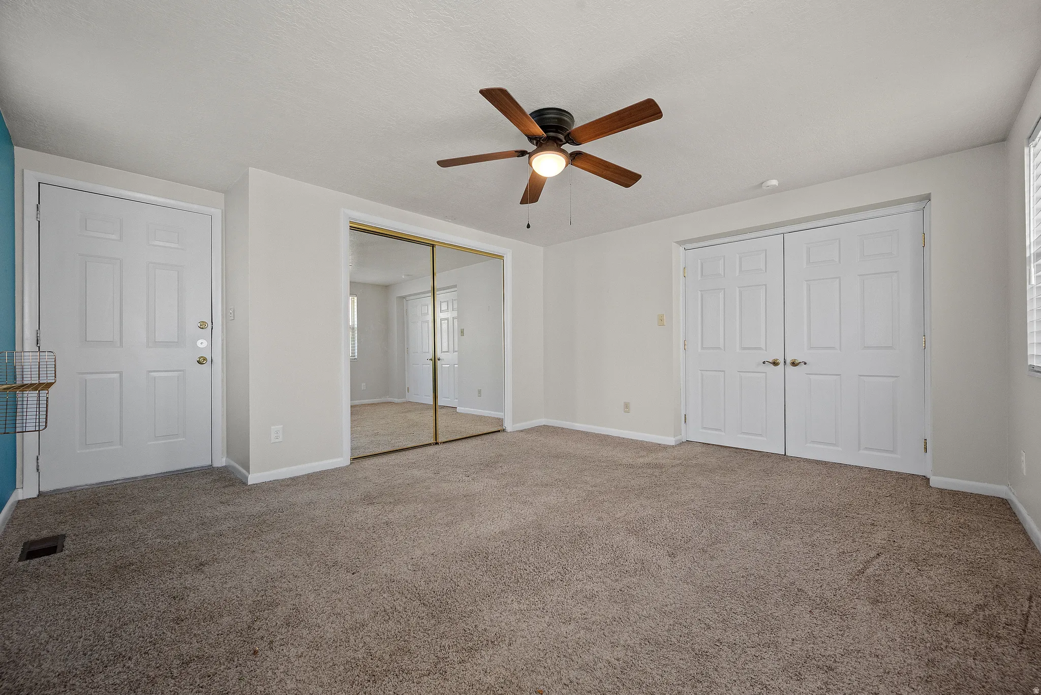 Unfurnished bedroom with carpet floors, a closet, and ceiling fan