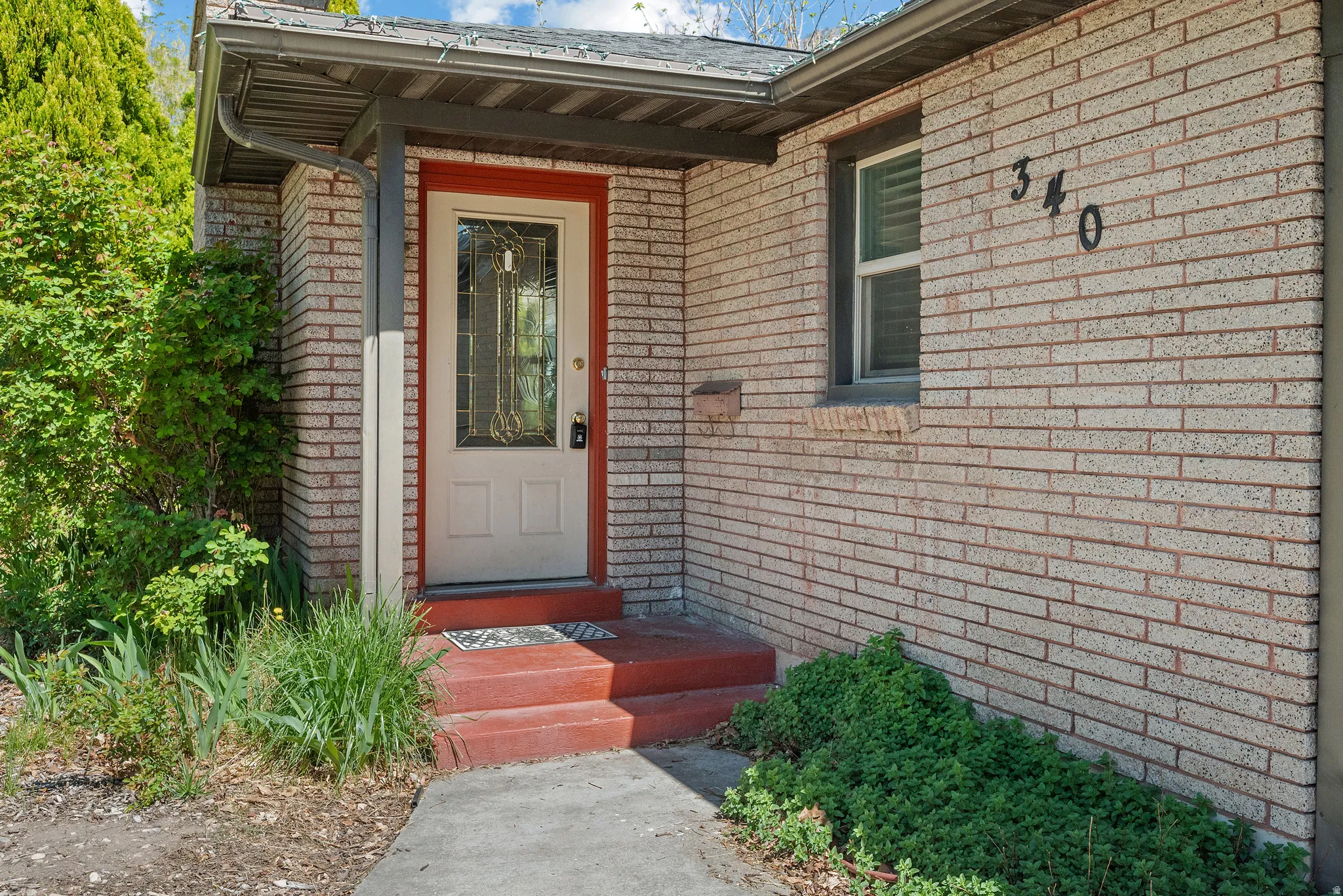 Doorway to property featuring brick siding