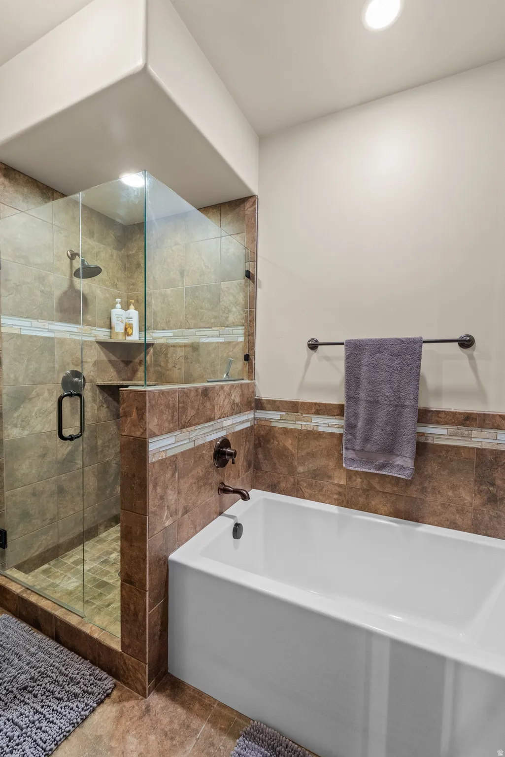 Full bath with a bath, a stall shower, recessed lighting, and tile walls
