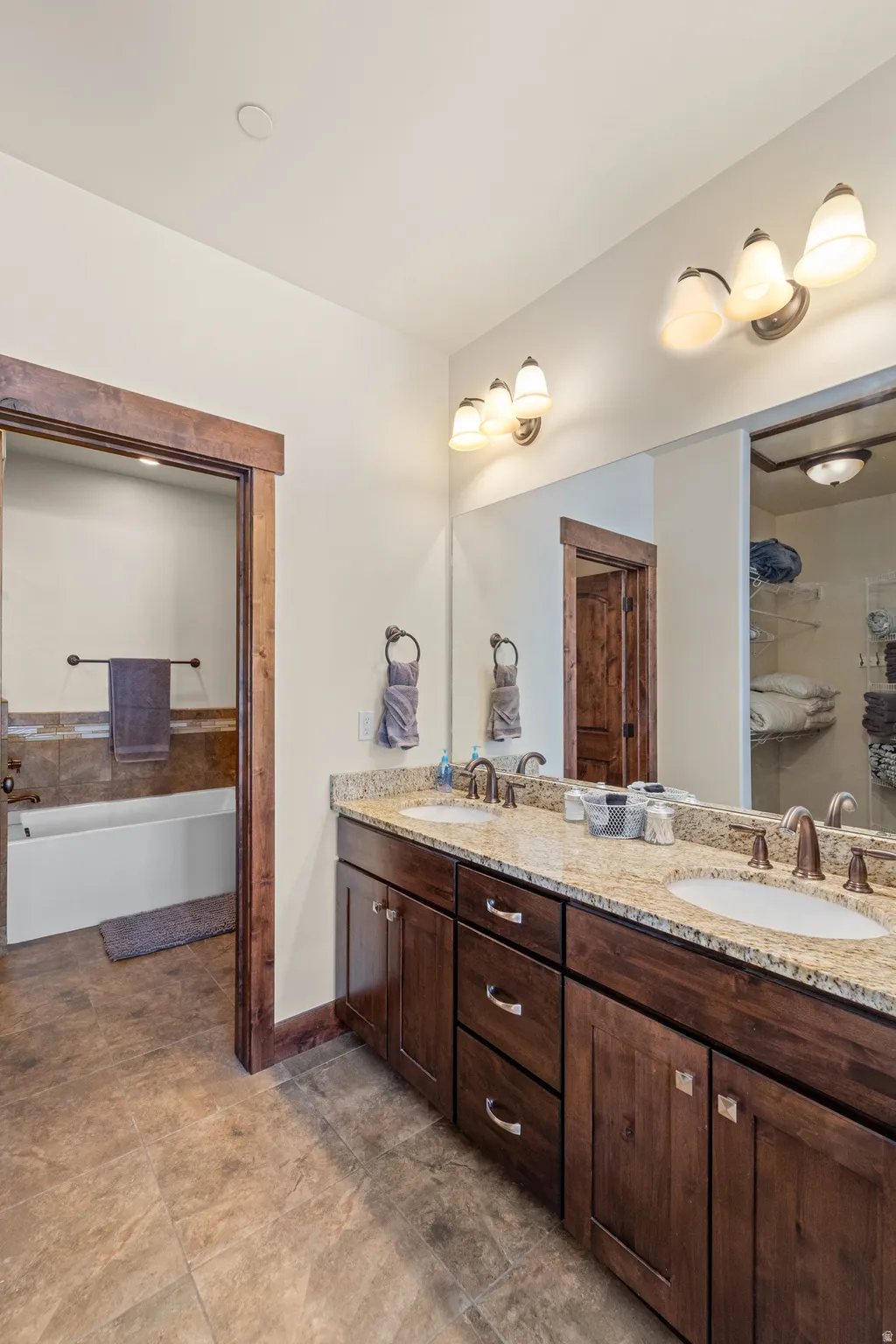 Bathroom with double vanity and a garden tub