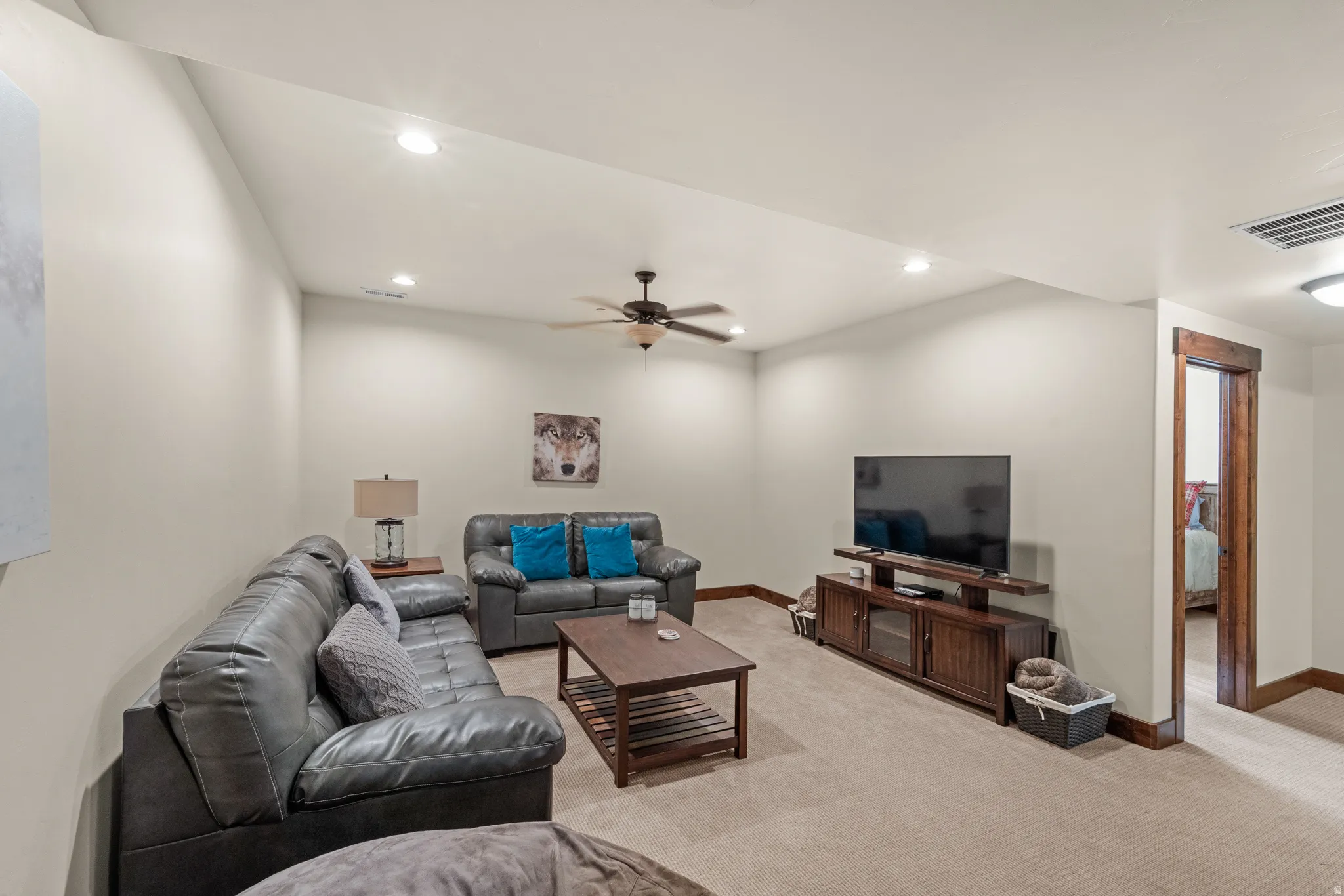 Living room featuring ceiling fan, light colored carpet, and recessed lighting