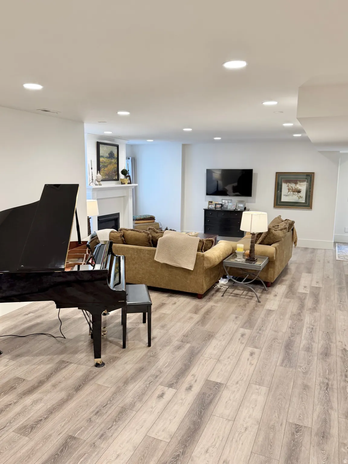 Living room featuring a fireplace, light wood-style flooring, and recessed lighting