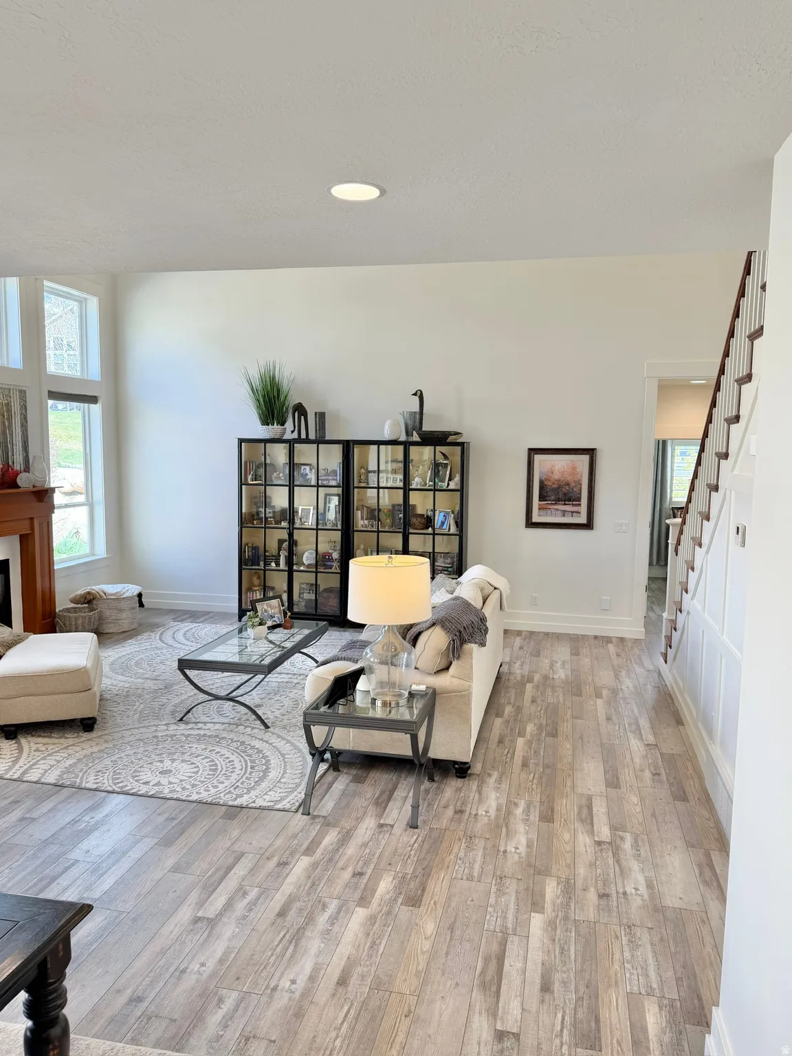 Living room with plenty of natural light, light wood-style flooring, and recessed lighting