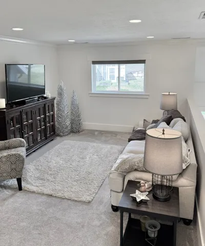 Living area featuring carpet flooring and crown molding