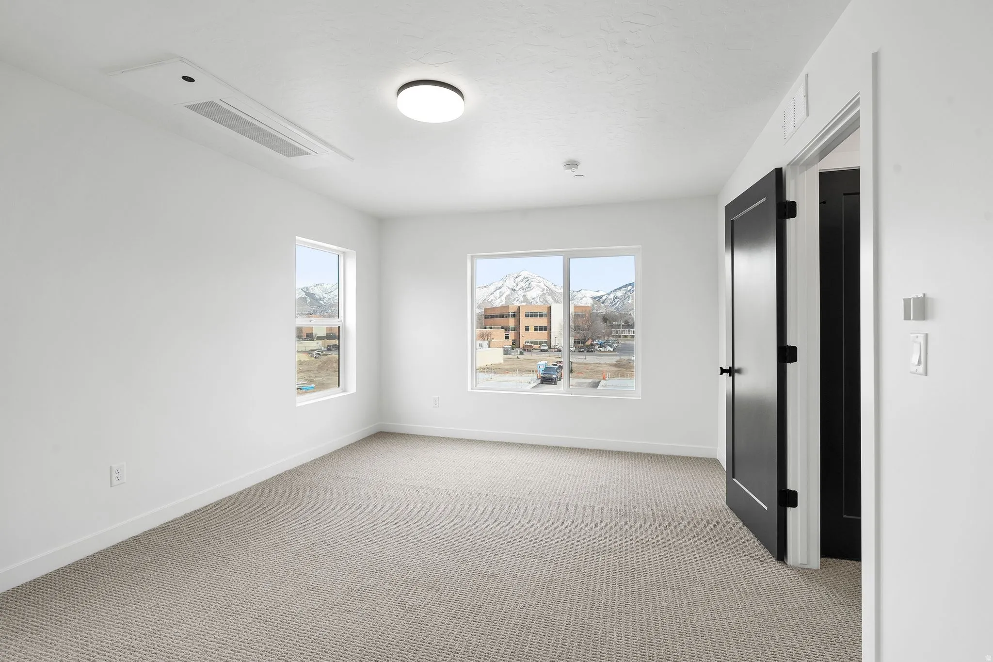 Unfurnished room with light carpet and baseboards