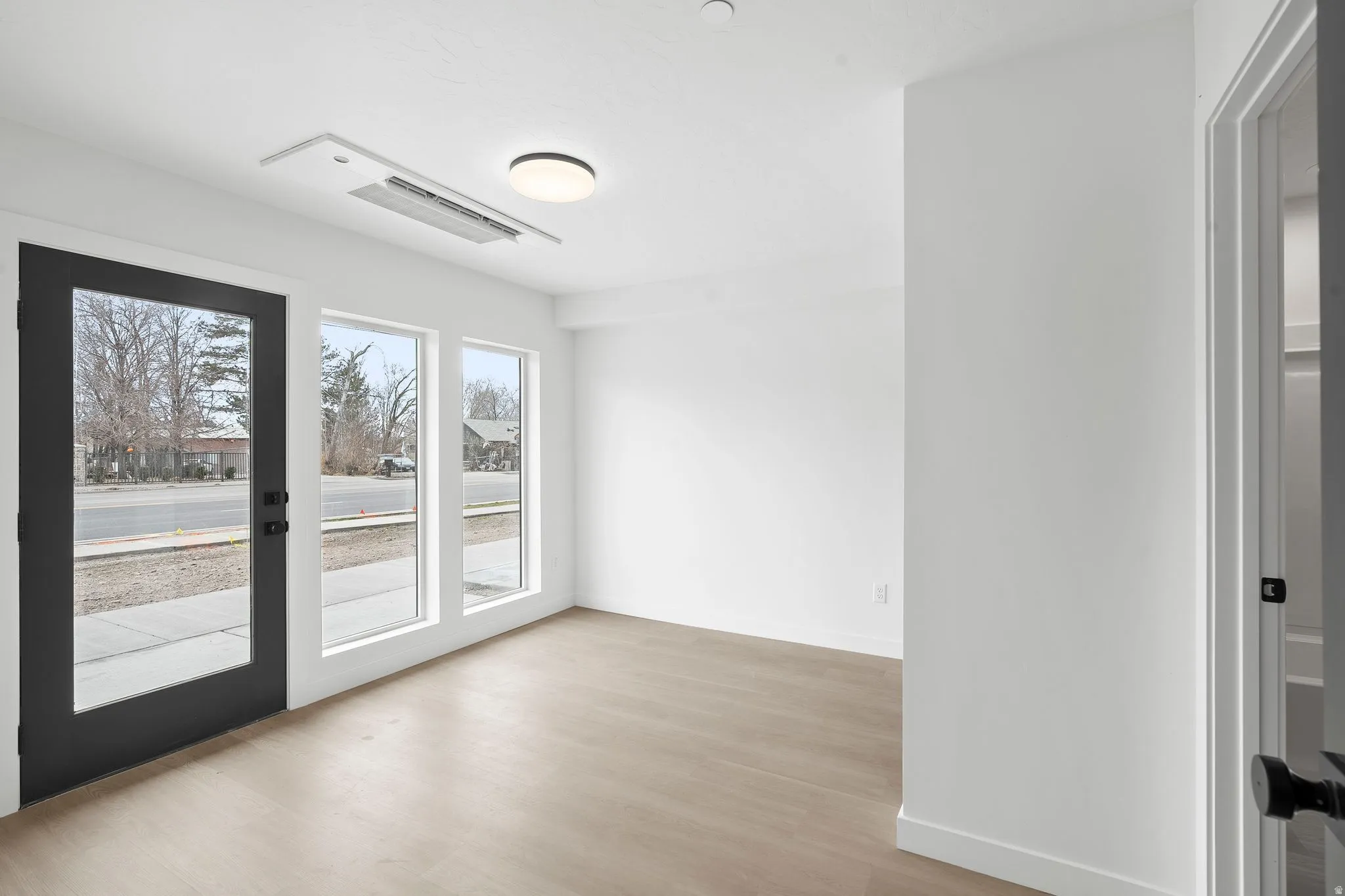 Empty room with light wood-type flooring and baseboards
