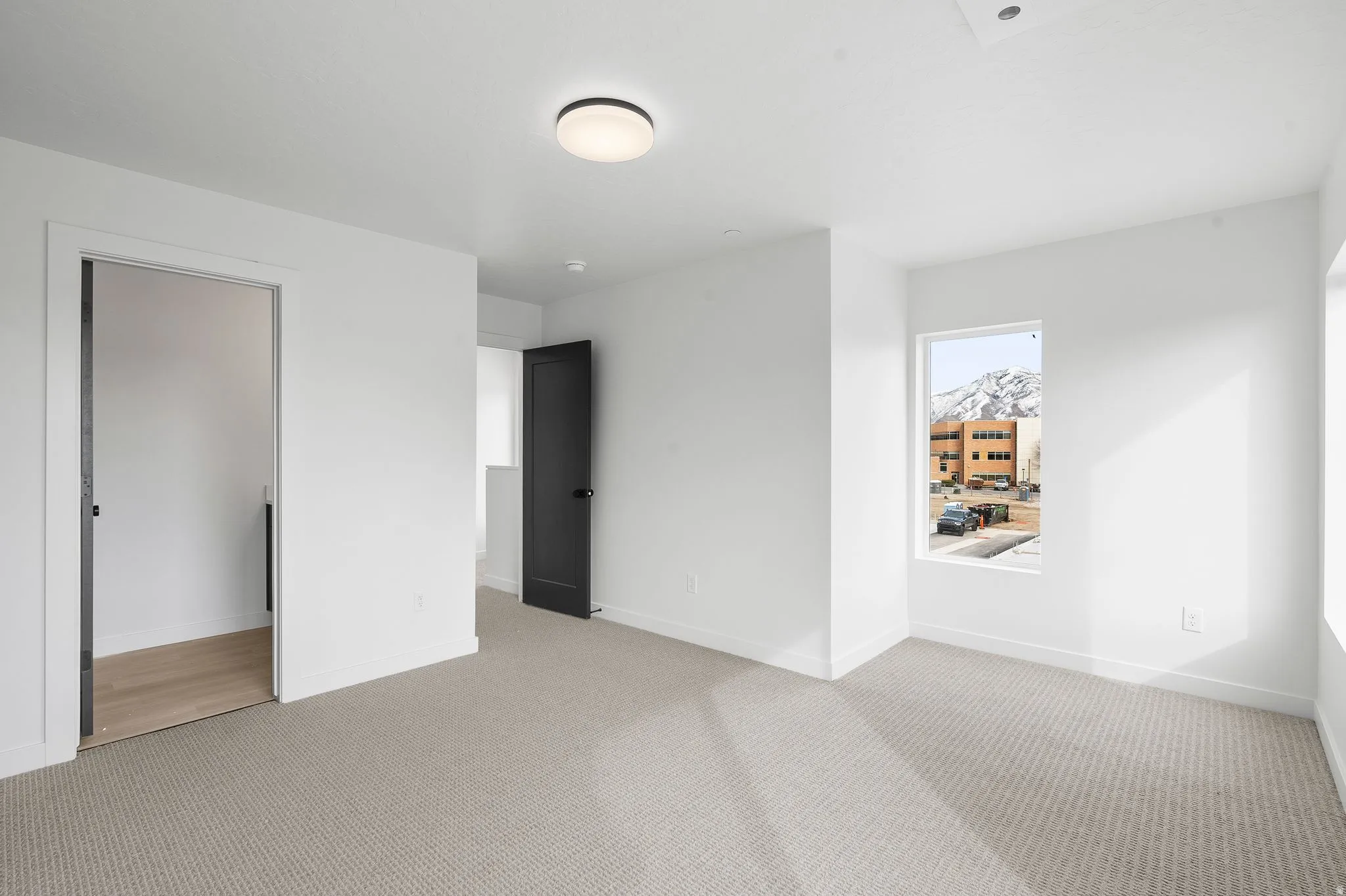 Unfurnished bedroom featuring baseboards and light carpet