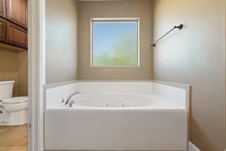 Bathroom featuring a whirlpool tub and tile patterned flooring