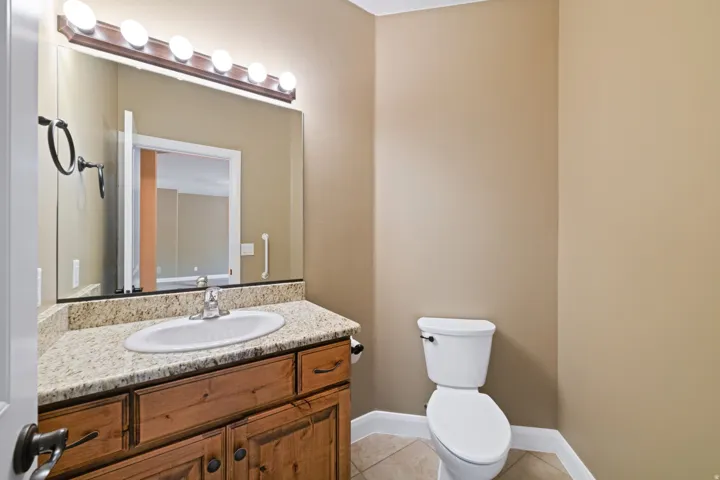 Half bathroom featuring vanity and light tile patterned floors