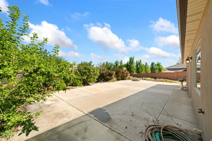 Fenced backyard with a patio