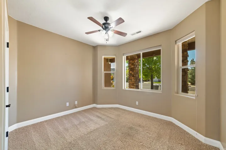 Spare room with ceiling fan and light carpet