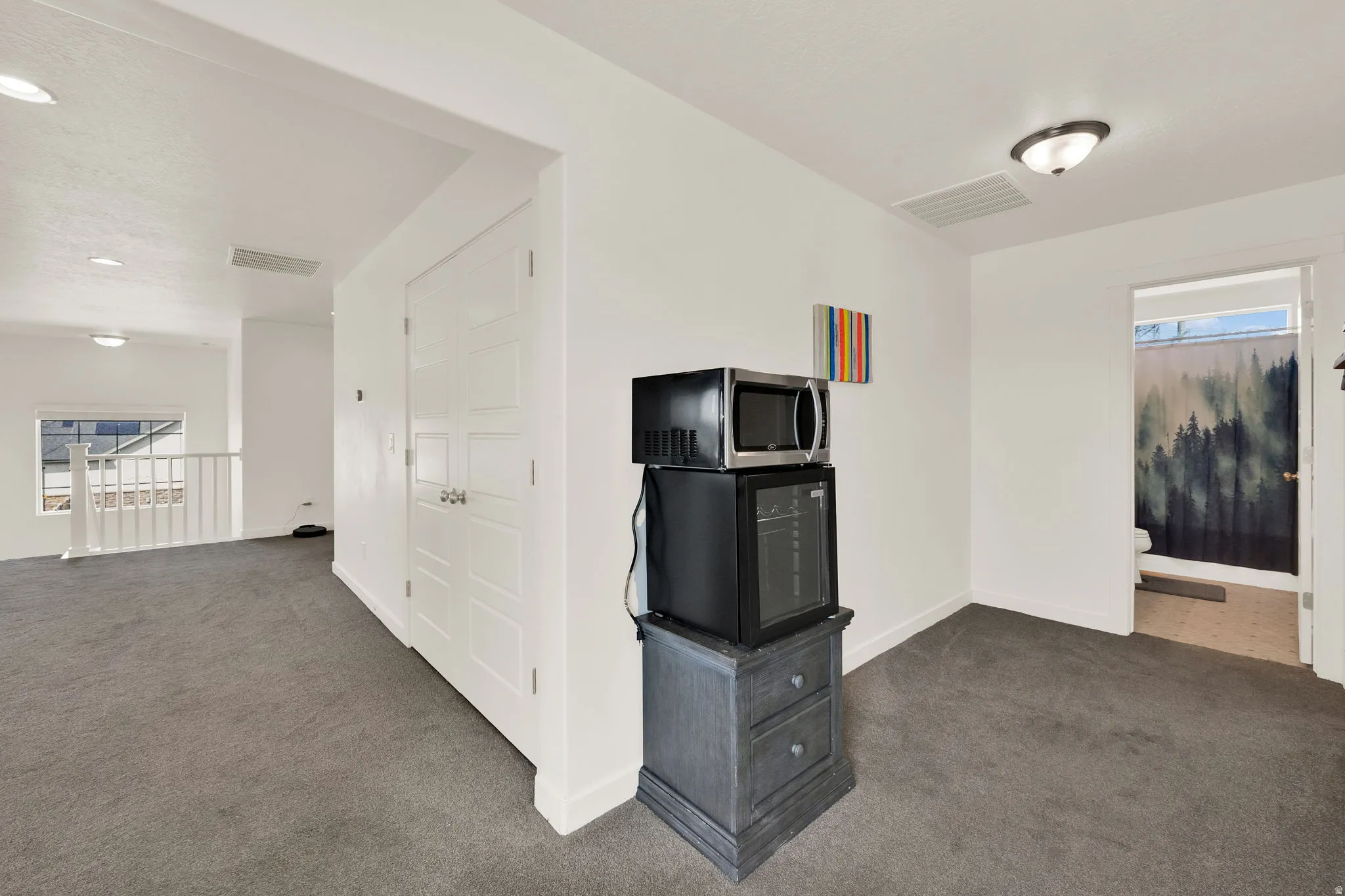 Unfurnished living room with dark carpet