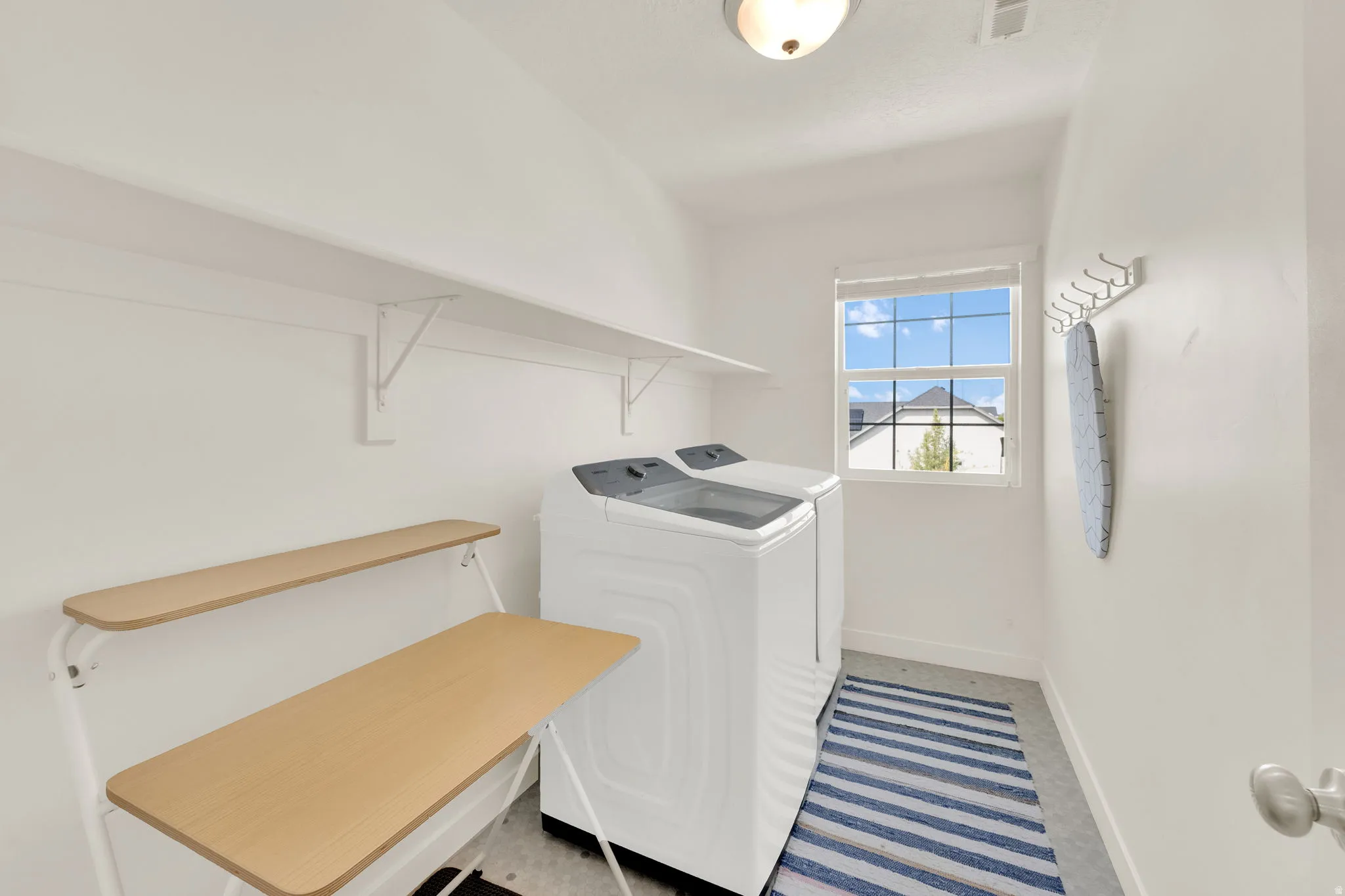 Laundry room featuring baseboards and washing machine and dryer
