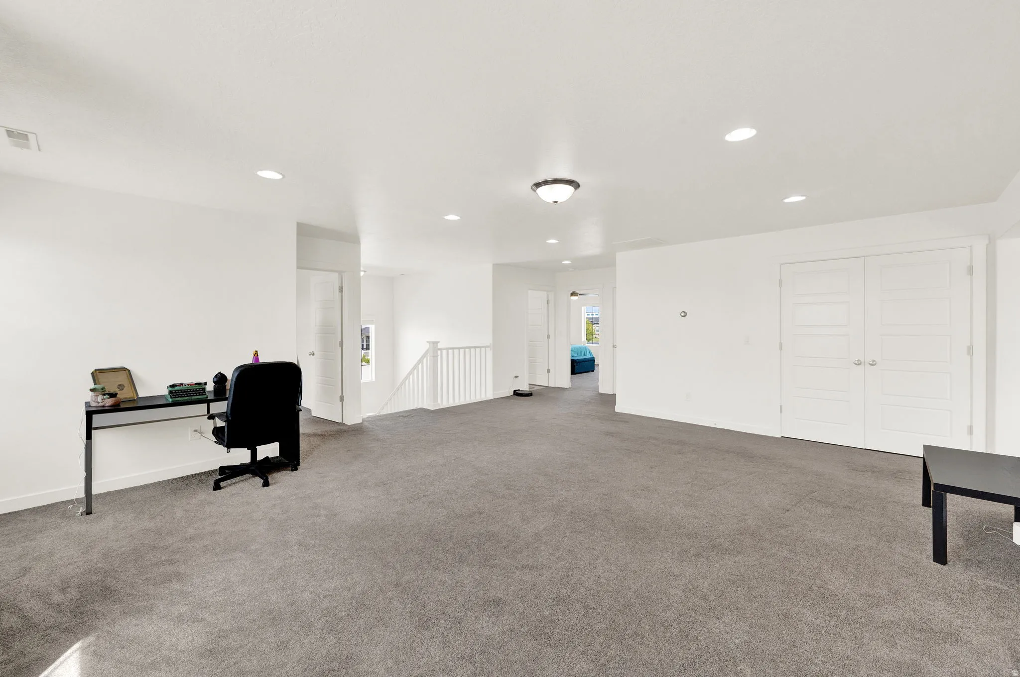 Carpeted office space featuring recessed lighting and baseboards