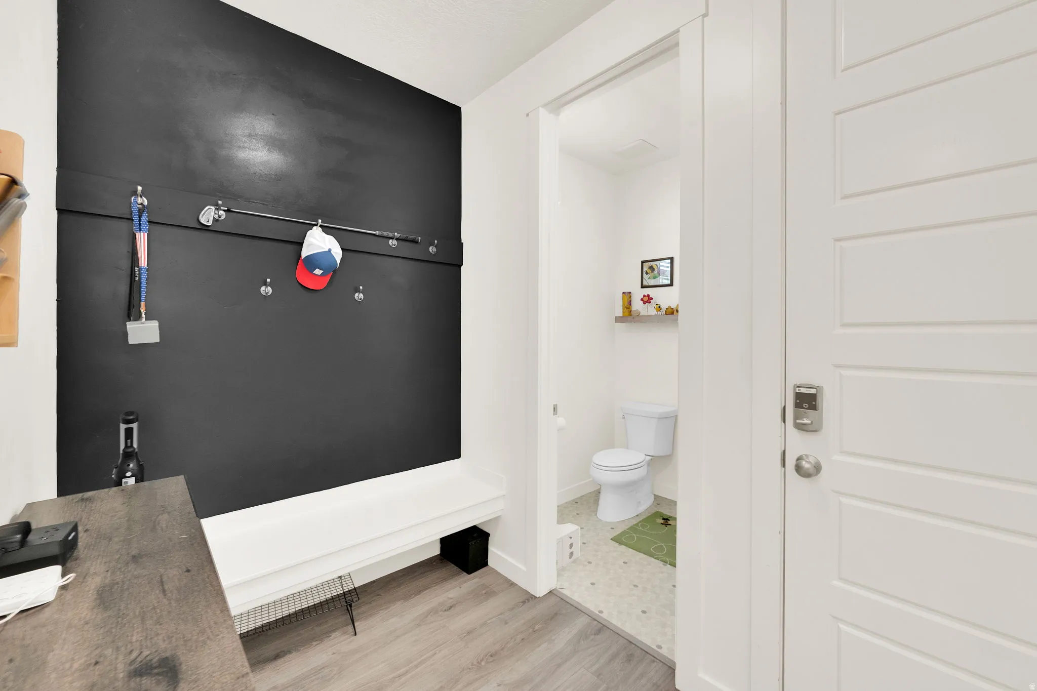 Bathroom featuring toilet and light wood finished floors
