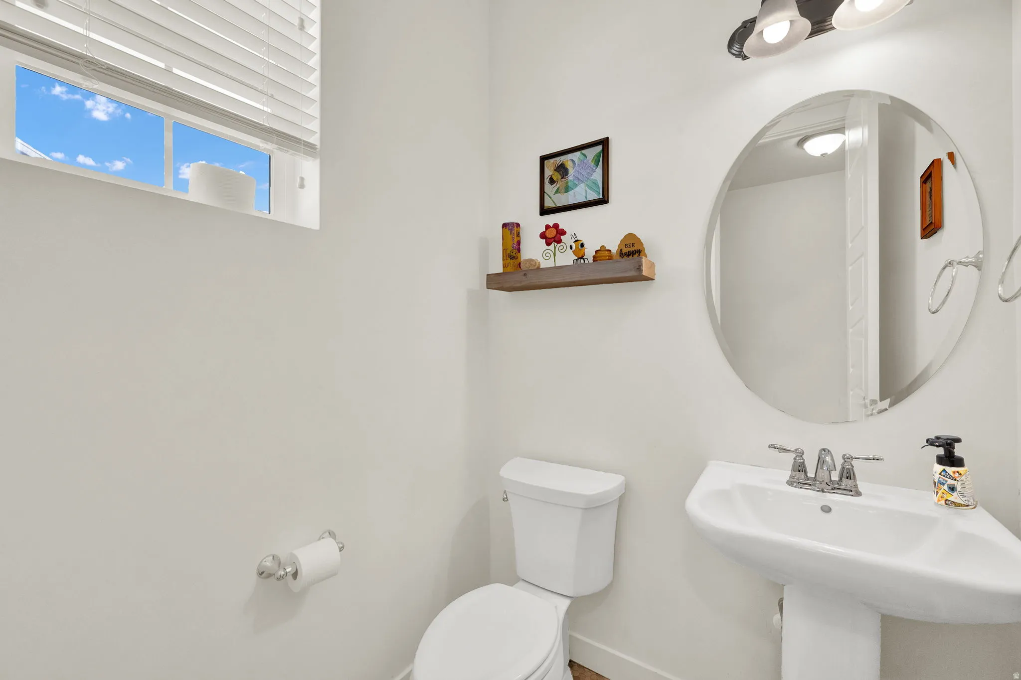 Half bathroom with toilet and baseboards