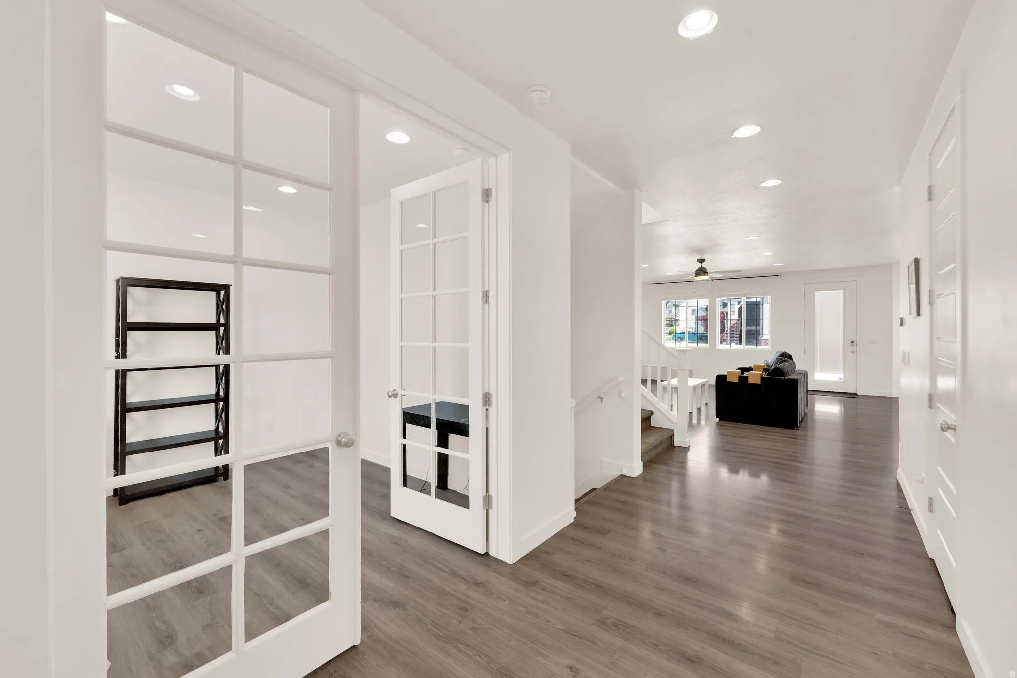Hall with recessed lighting, dark wood-type flooring, and french doors