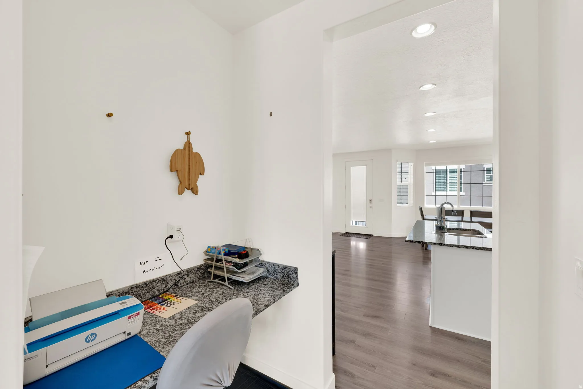 Kitchen with a desk, recessed lighting, dark wood-style floors, dark stone counters, and white cabinetry