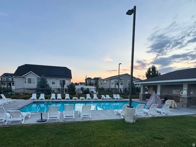 Outdoor swimming pool featuring a surrounding concrete deck and multiple lounge chairs