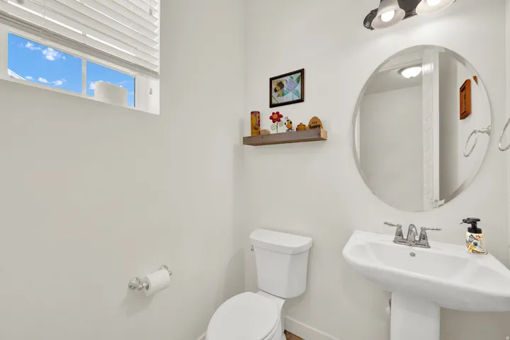 Half bathroom with toilet and baseboards